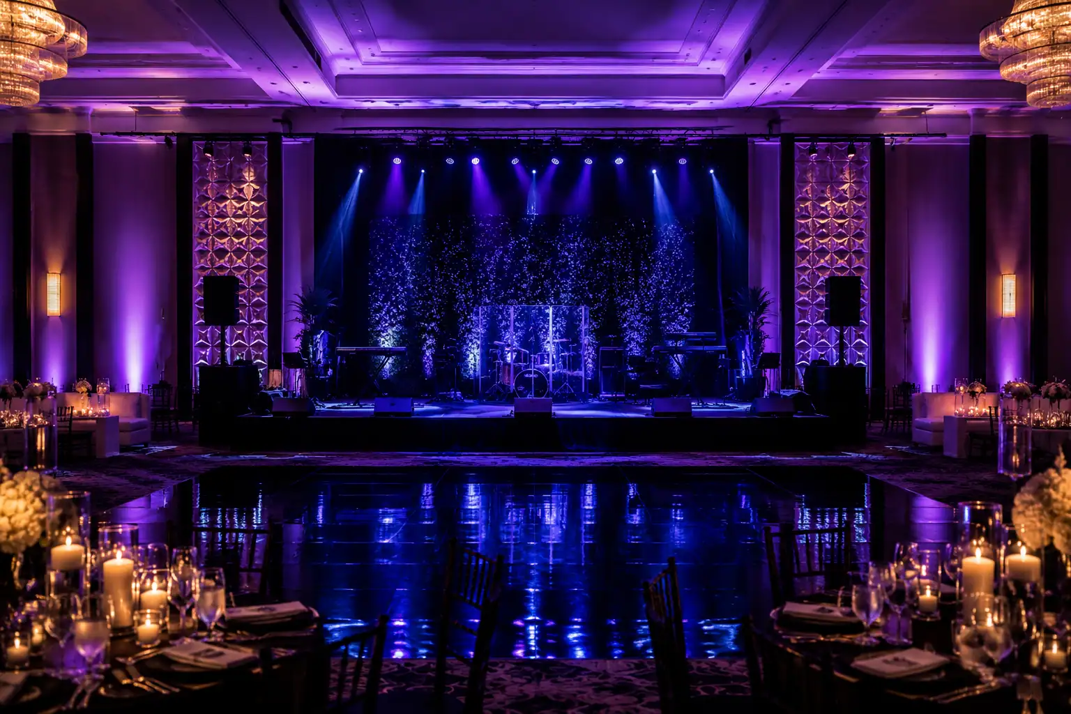 Orlando ballroom with custom purple and blue lighting, illuminated stage and reflective flooring