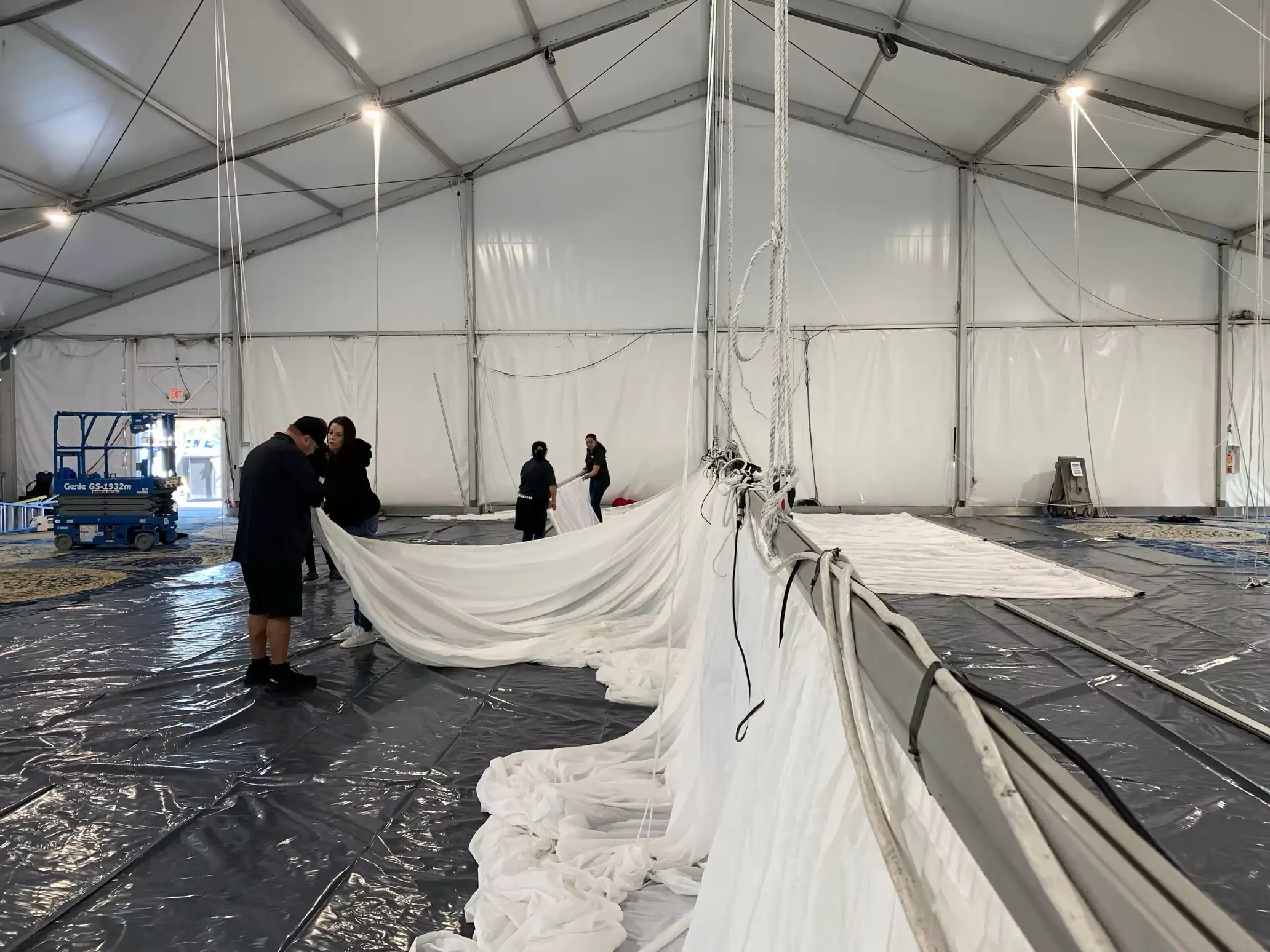 Event tent ceiling lighting installation during replacement of the pavilion fabric draping