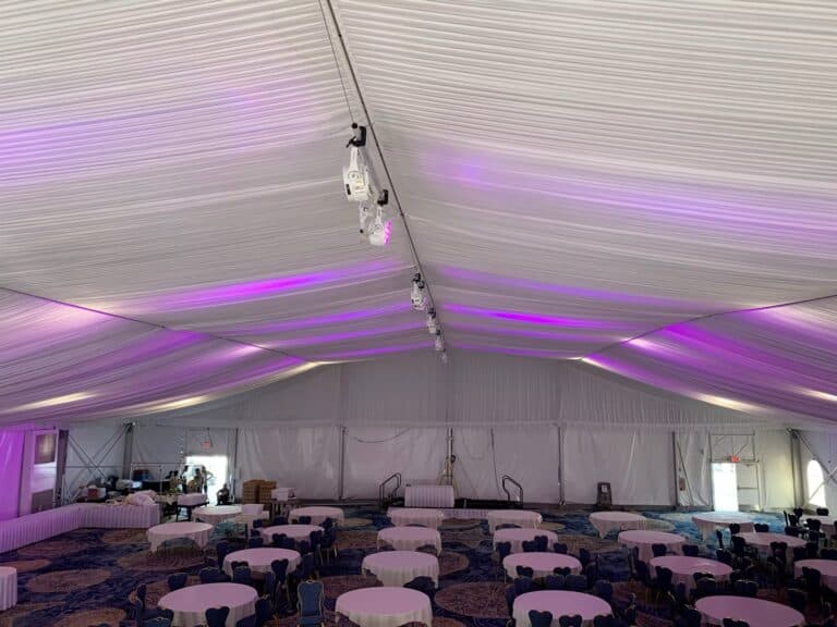 Lavender LED lighting illuminating the draped ceiling of an event pavilion