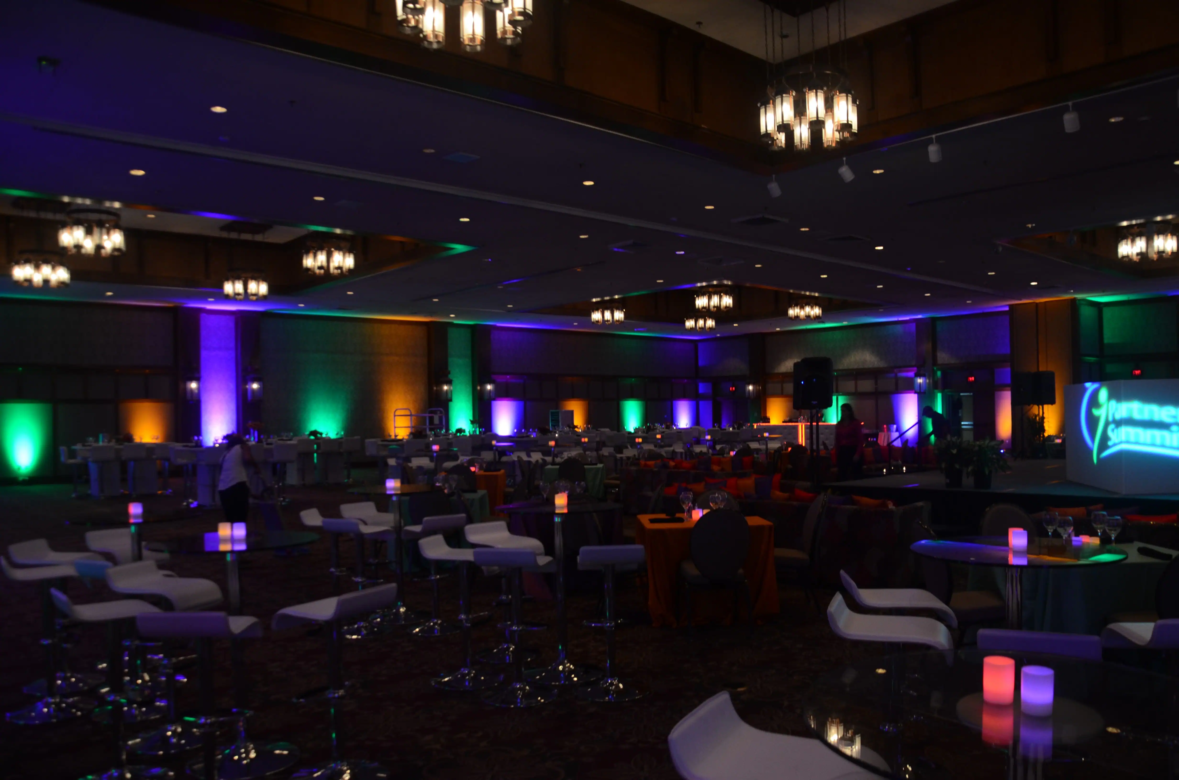 Colorful uplighting illuminating the walls of an Orlando ballroom event