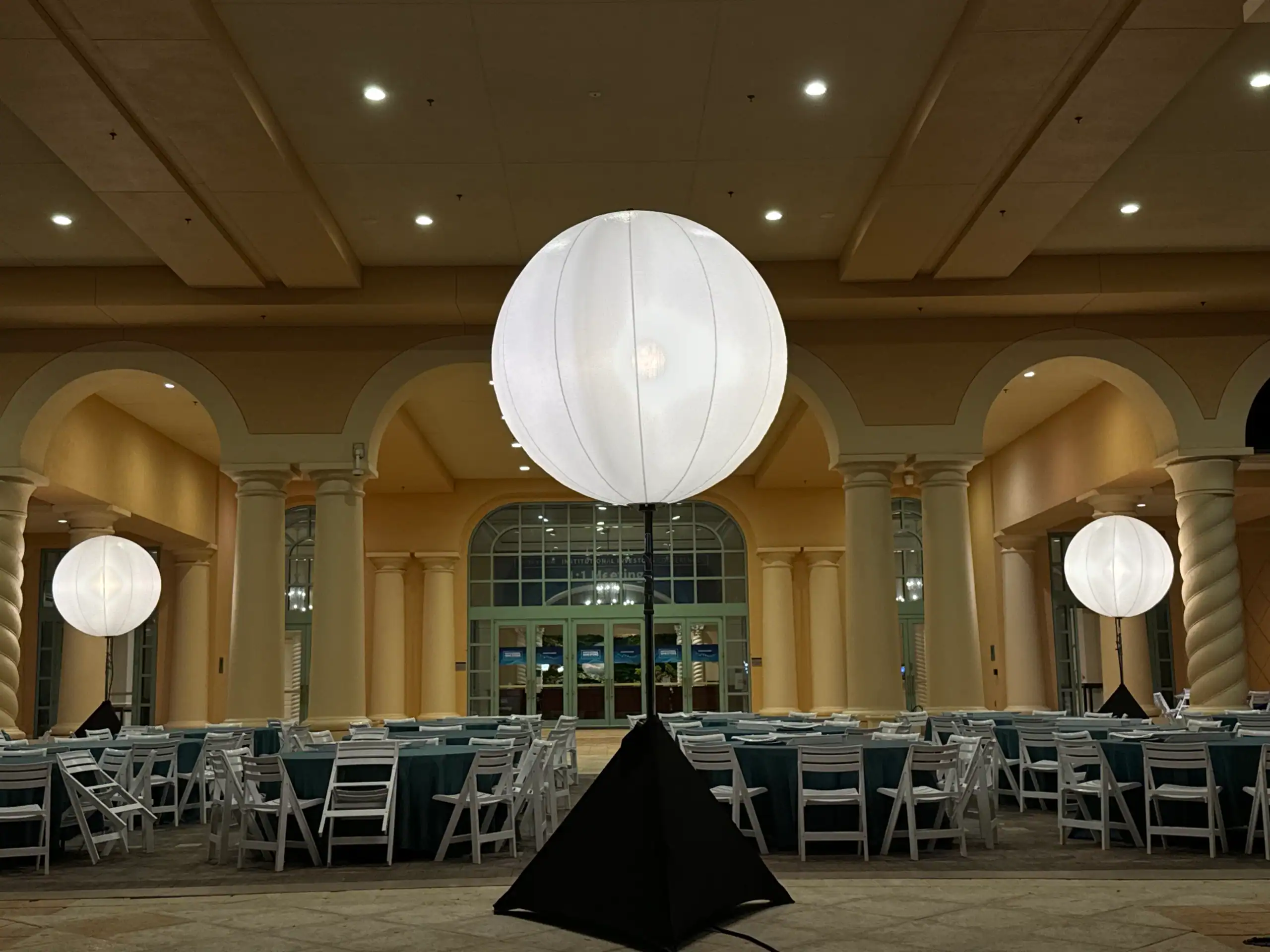 Airstar illuminated globe fixture used in an indoor event lighting design