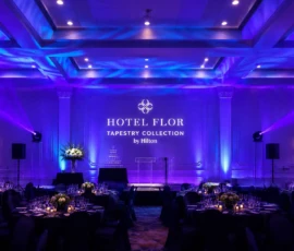 Elegant corporate event ballroom featuring professional blue and purple lighting design in Orlando.