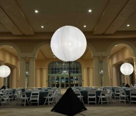 Illuminated air-filled spheres installed throughout an Orlando ballroom event