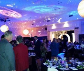 Patterned GOBO projections illuminating the ceiling above an indoor event