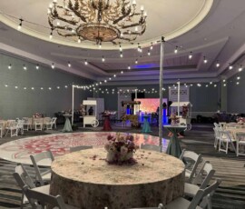 Bistro string lighting suspended over an indoor Orlando event reception space