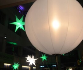 Large air-filled sphere surrounded by illuminated star lighting at an Orlando event