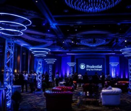 Luxury corporate event lighting installation featuring custom LED ring fixtures and architectural lighting in an Orlando ballroom.