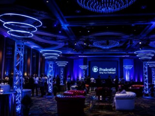 Luxury corporate event lighting installation featuring custom LED ring fixtures and architectural lighting in an Orlando ballroom.