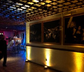 Warm amber wall uplighting with blue and pink accent lighting inside an Orlando event venue