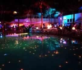 Colorful outdoor event lighting surrounding a pool at an Orlando venue