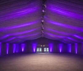 Permanent architectural event lighting illuminating a luxury Orlando venue with custom purple uplighting by TYLERLIGHT.