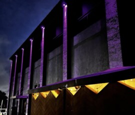 Purple and amber exterior architectural lighting on a commercial building in Orlando