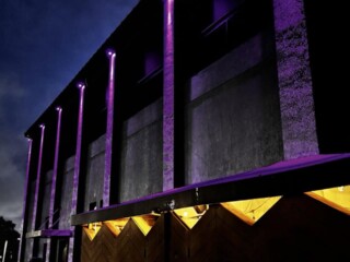 Purple and amber exterior architectural lighting on a commercial building in Orlando