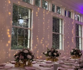 Elegant Orlando wedding reception with warm twinkle lights behind decorated dining tables